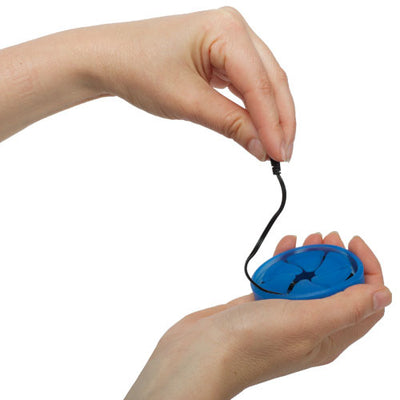 Photo of a pair of hands demonstrating how to pull a pair of earbuds from a blue Nest.
