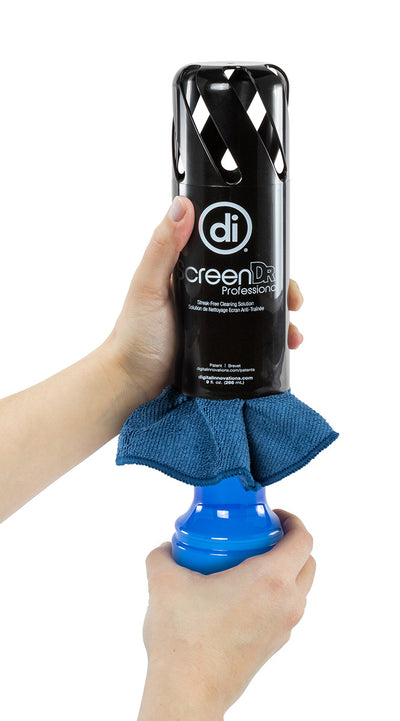Studio photo of a pair of hands opening the ScreenDr cleaning system by grabbing a blue bottle of solution with one hand and a black vented cap with the other hand. Also shows a blue microfiber cloth in between the cap and bottle.