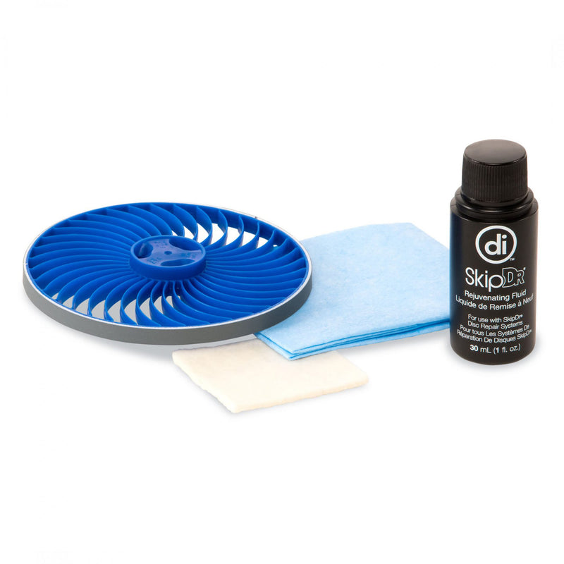 Studio photo of the SkipDr Replacement Kit, including blue Flexiwheel, white buffing square, blue cloth, and small black bottle of Rejuvenating Fluid.